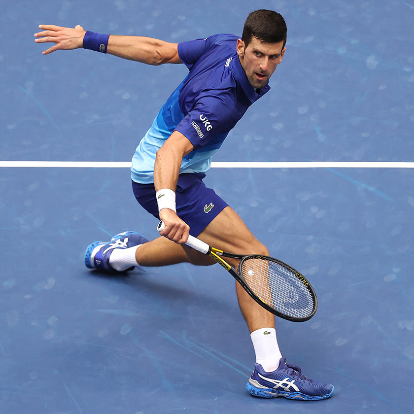 Novak Djokovic in court tossing a tennis ball