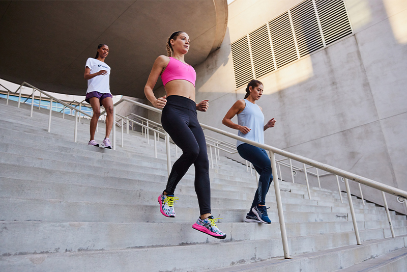 Three people walking down the stairs