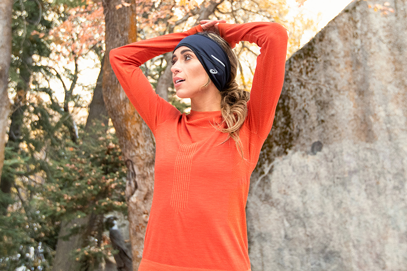 Women stretching outside wearing outdoor gear